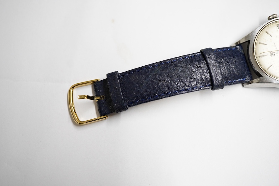 A gentleman's stainless steel Girard Perregaux Gyromatic wrist watch, with baton numerals, case diameter 33mm, on a later associated leather strap, no box or papers.